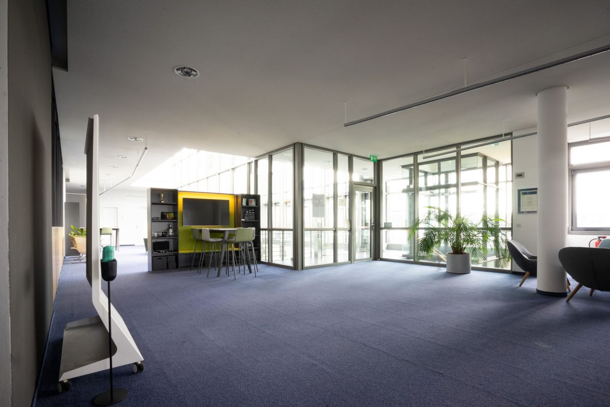 Besprechungsbereich mit Medienunterstützung und Stauraum auf offene Bürofläche
