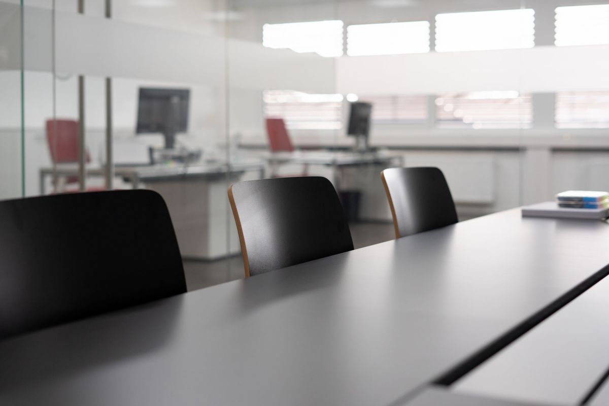 Geradlinger Besprechungstisch mit Strom- und Datenanschlüsse unter Kabelklappe