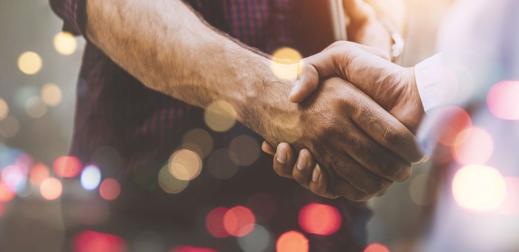 Zwei Personen geben sich die Hand